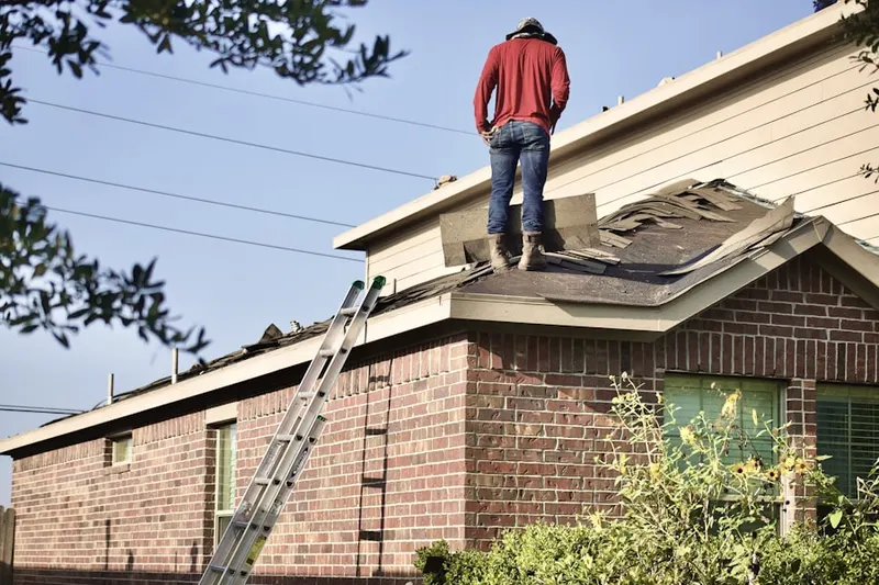 Professional roofer working on a residential roof in Killingly